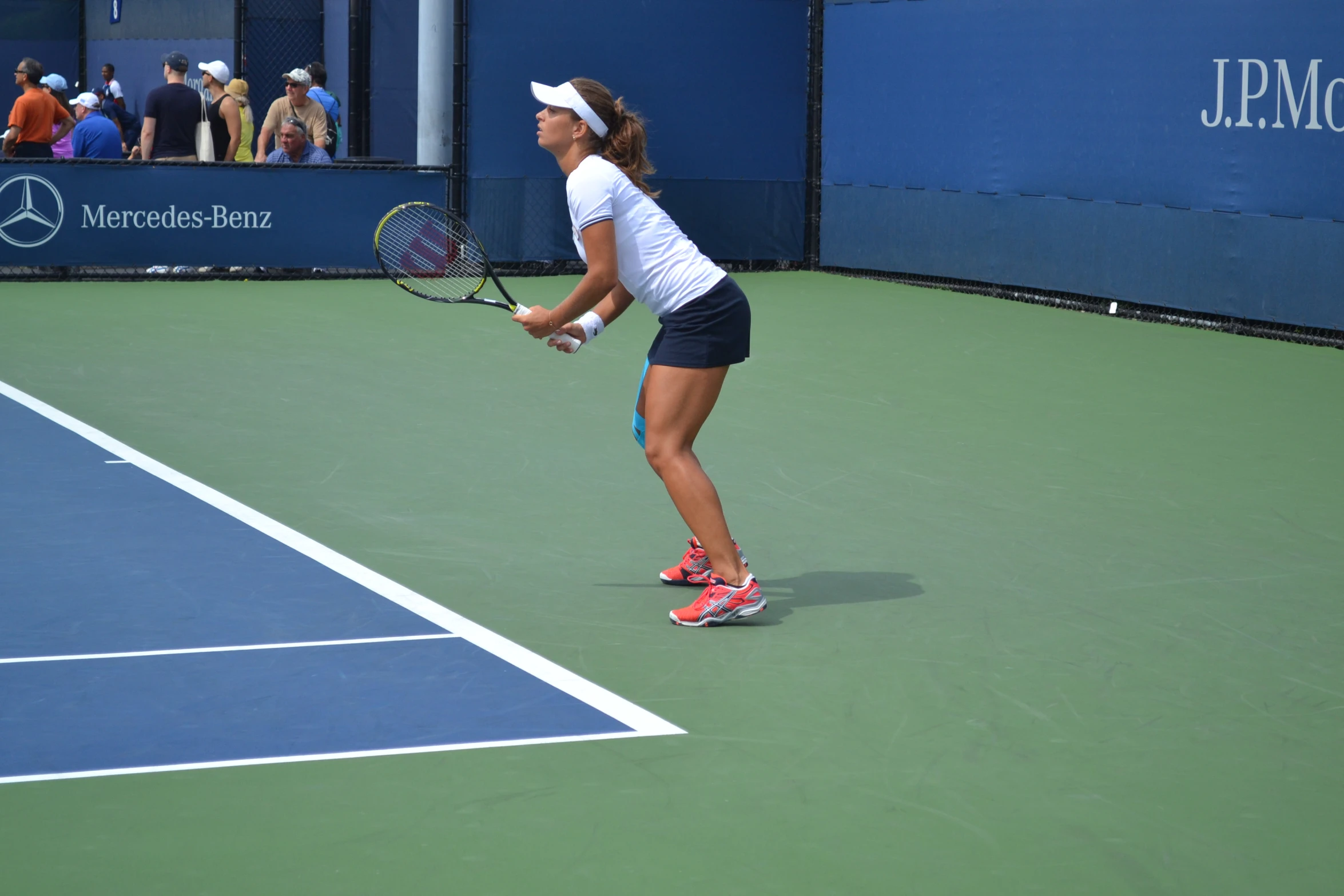 a woman is playing tennis on a green court