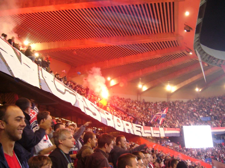 many people in a stadium watch the fireworks