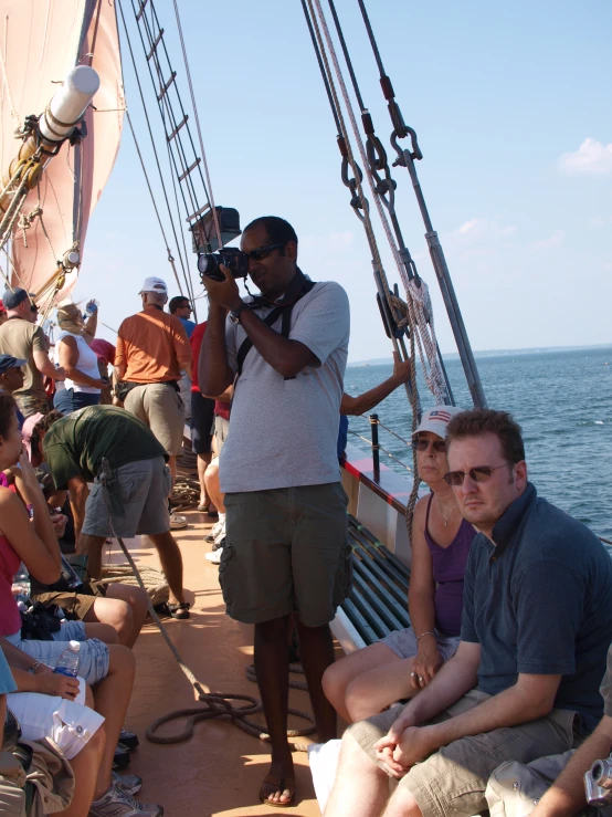 a group of people on a boat with cameras