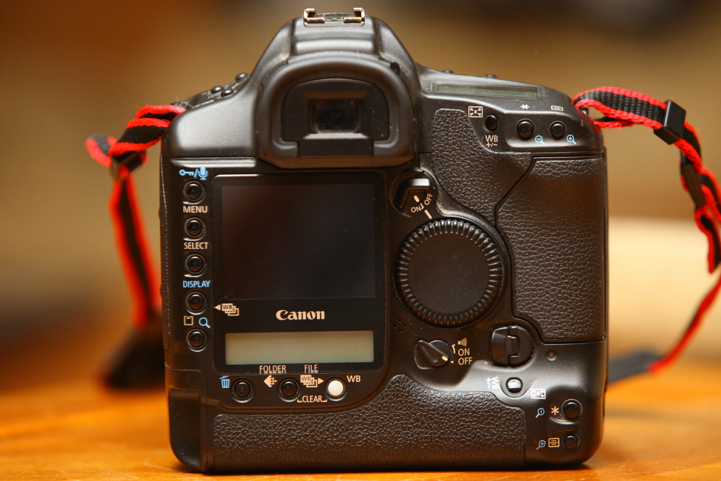 the front view of a black camera on a table