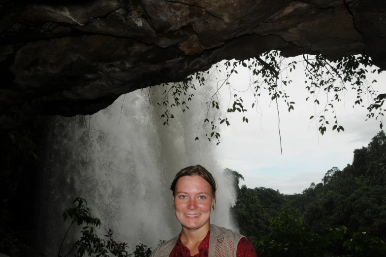 woman posing for a po in front of waterfall