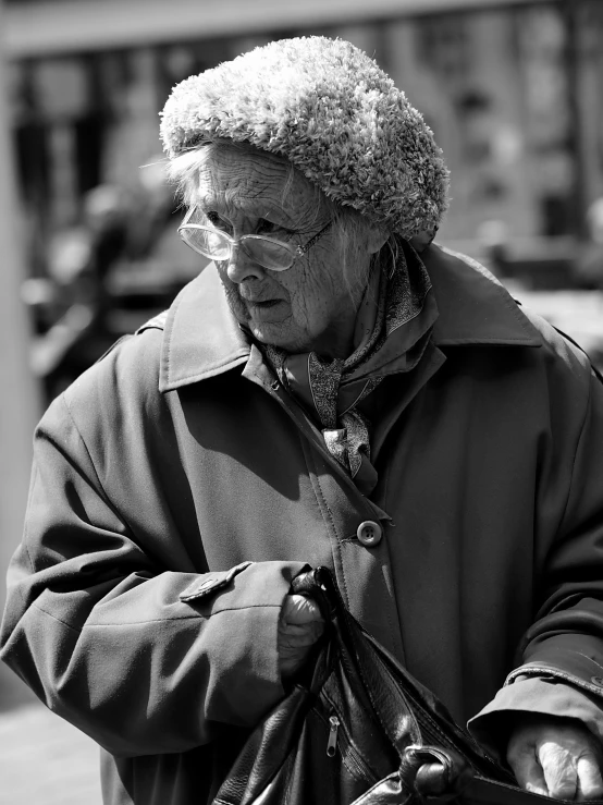 the man in glasses is walking while wearing a helmet and jacket