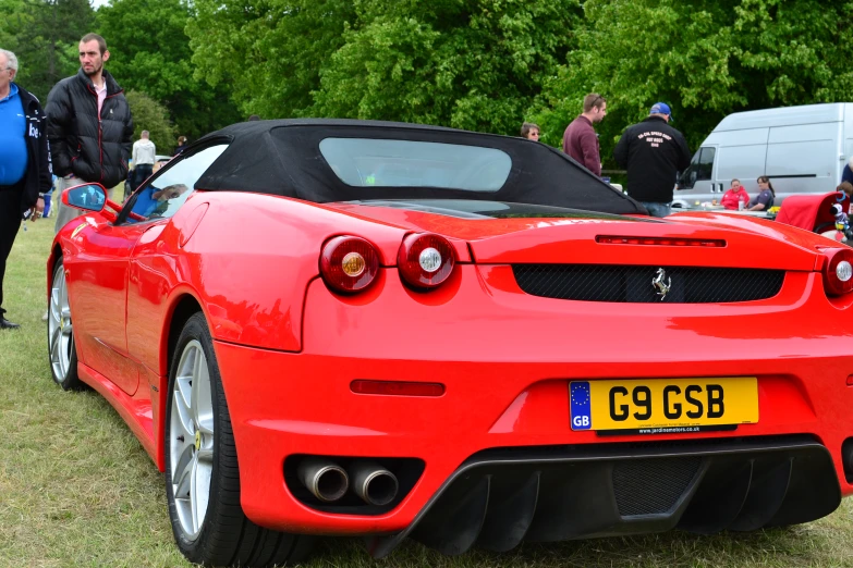 a bright red sports car with its hood down