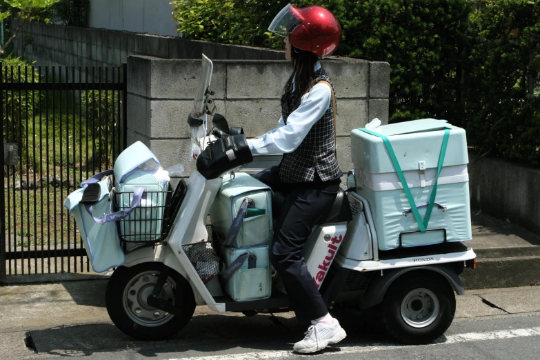 a person riding a scooter with crates on it