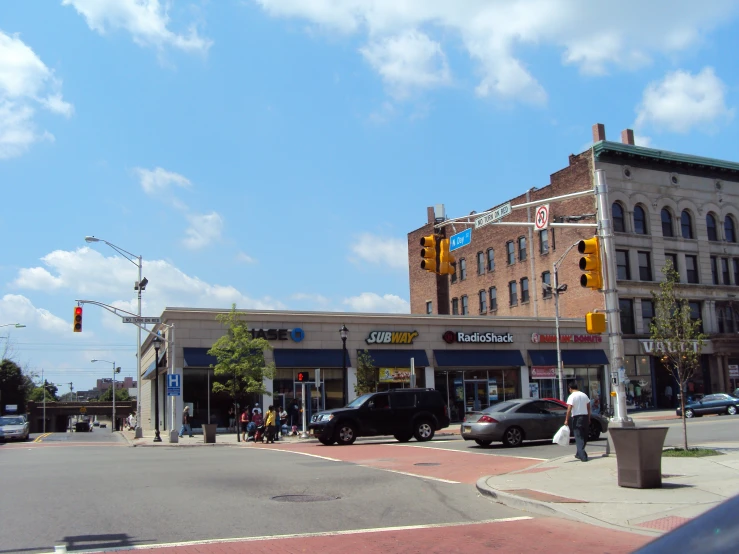 the intersection of a street in front of a retail building