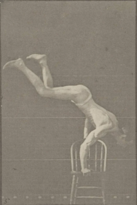 a man who is leaning on a chair and falling off