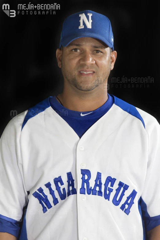 a baseball player posing for a picture in his uniform