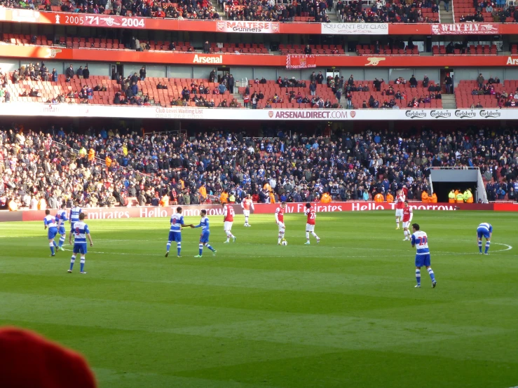 a soccer game is being played on a crowded soccer field