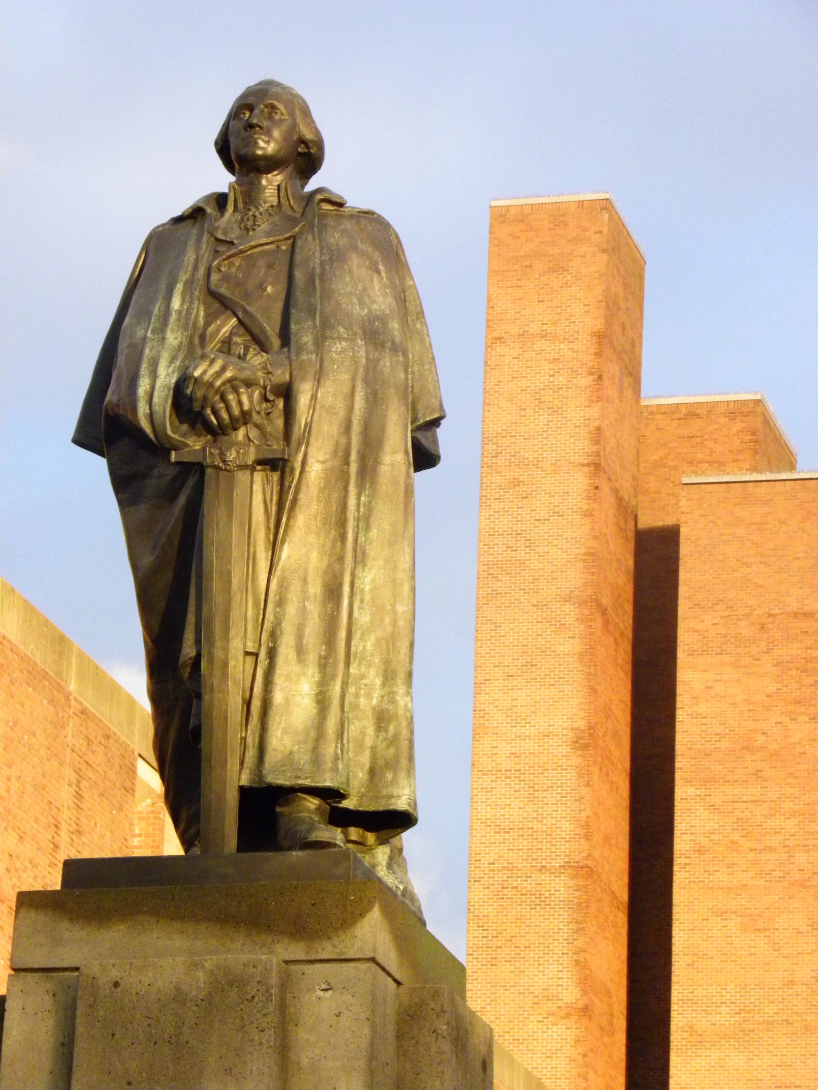 an interesting statue of a man in the middle of the town