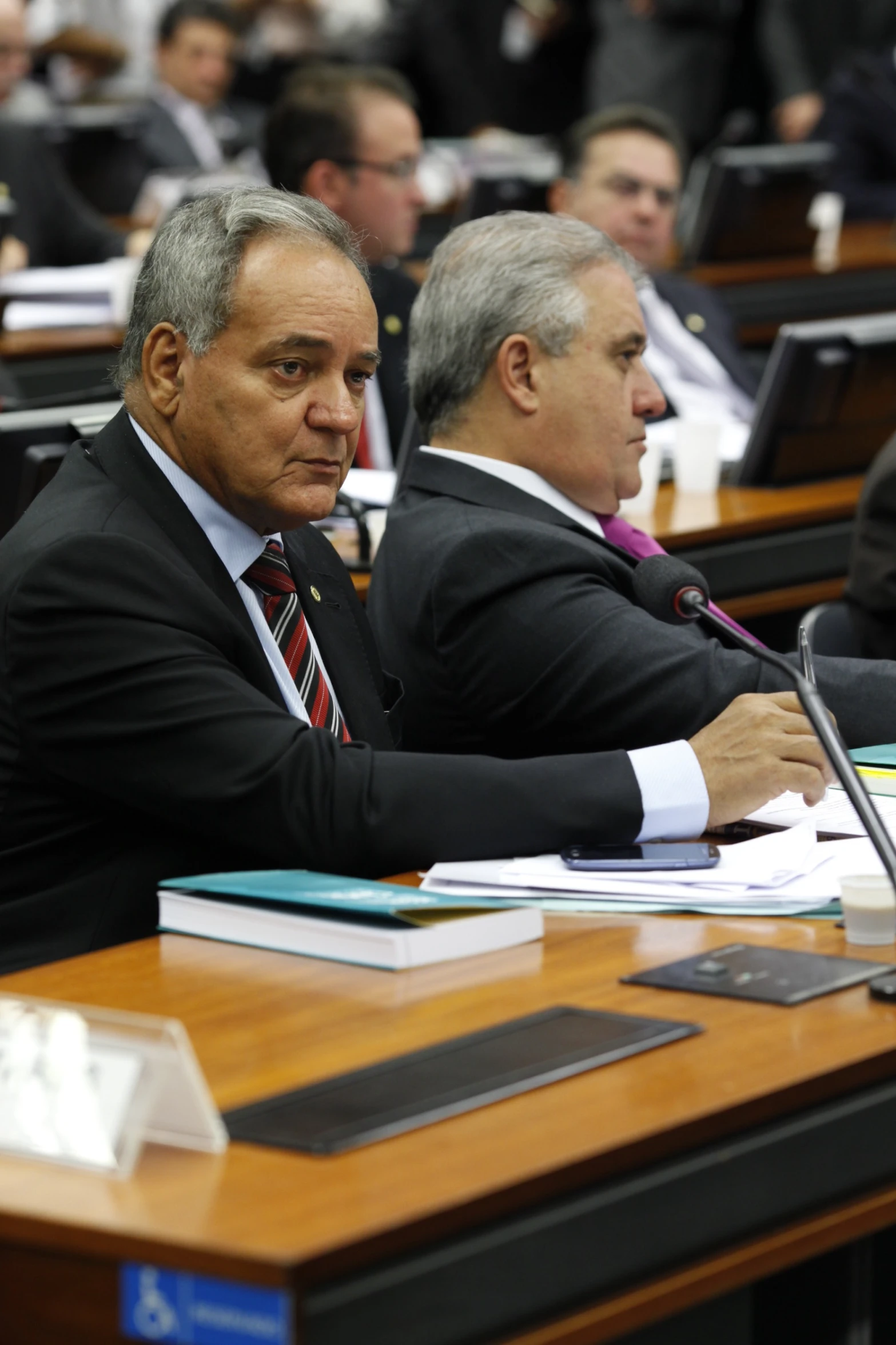 people in the middle of an audience in a conference hall