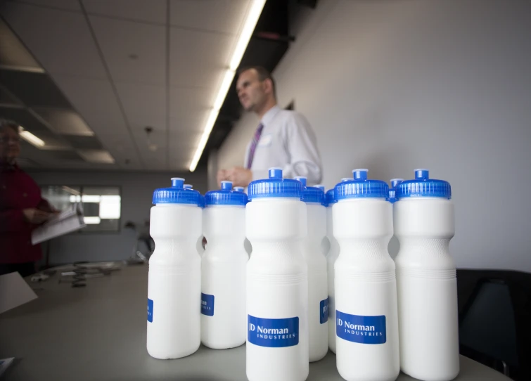 many white and blue water bottles on a table