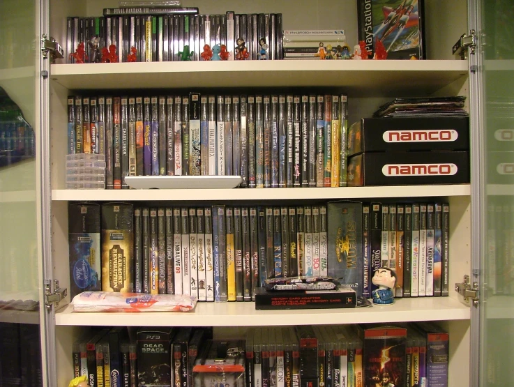 various dvd's on shelves in a room with glass doors