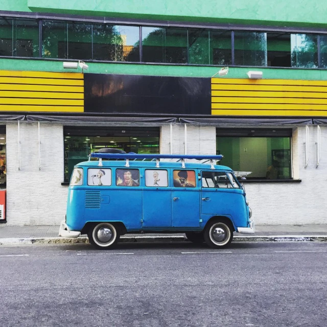 a van with luggage on top of it parked on the side of the street