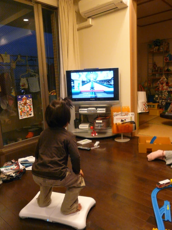 two young children playing with an interactive video game