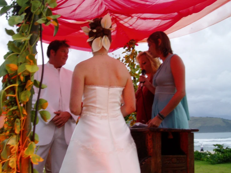 the bride is getting married at the beach side