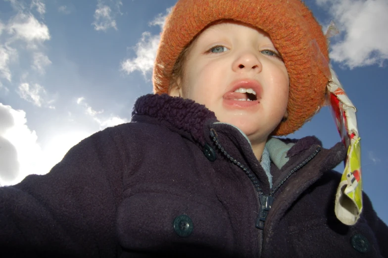 a small child with his eyes open with a tie in front of him