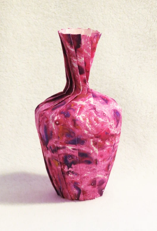 there is a decorative pink vase with flowers