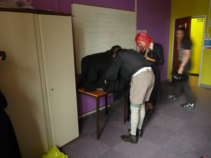 a woman standing in a room with another woman