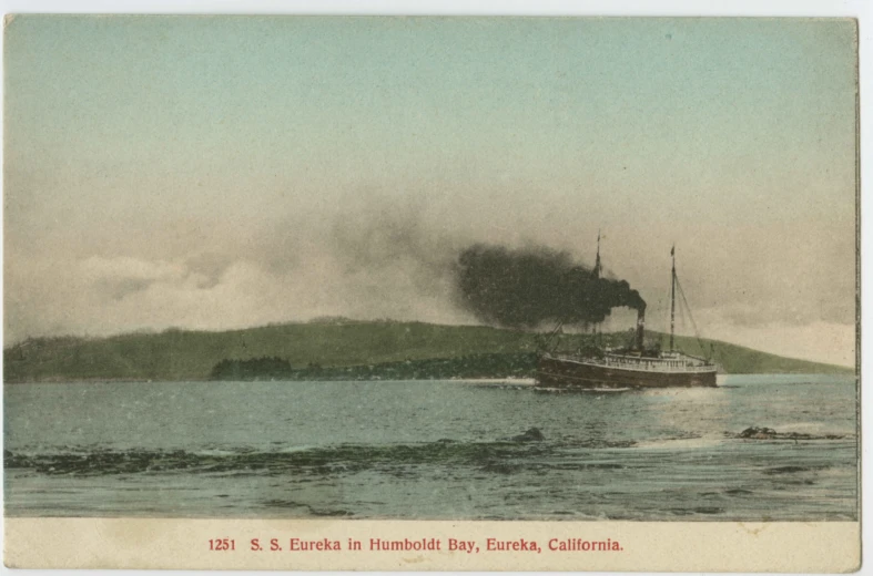 a ship out on the water, with smoke coming out