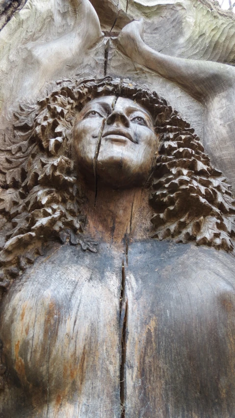 an intricately detailed wooden statue of a woman's face