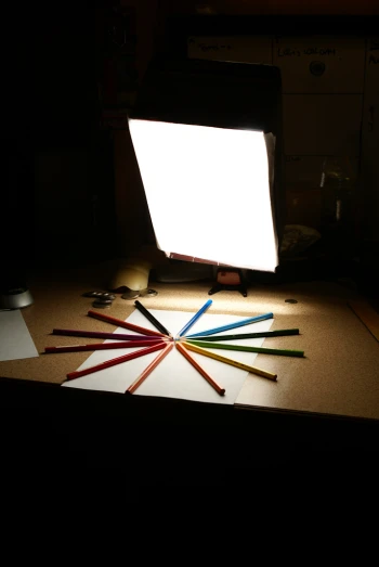 a lamp and a bunch of pencils on a table