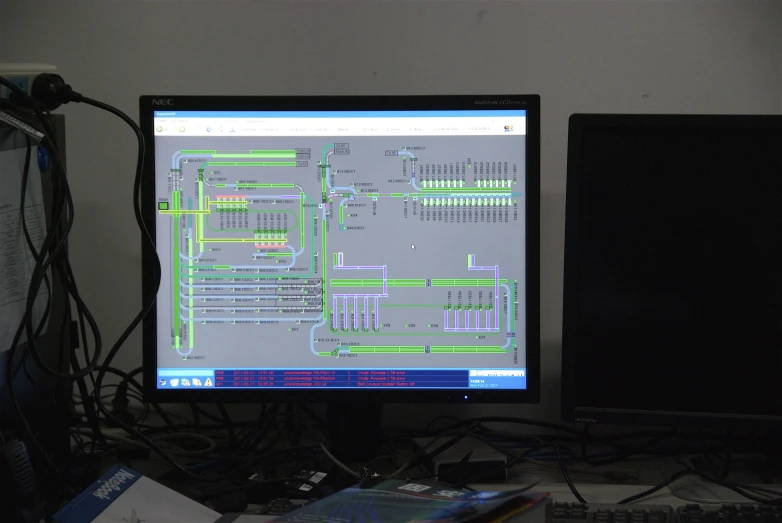 computer monitor with circuit board diagram in dark room