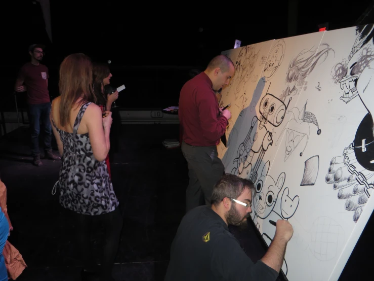 a group of people standing around and drawing