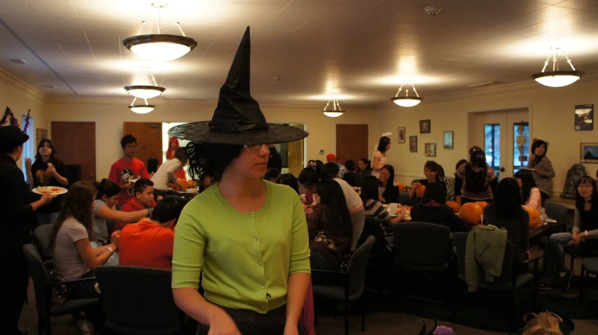 a room filled with people wearing halloween costumes