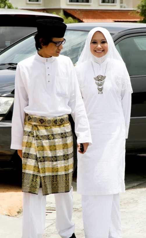 two women are standing next to each other on the sidewalk