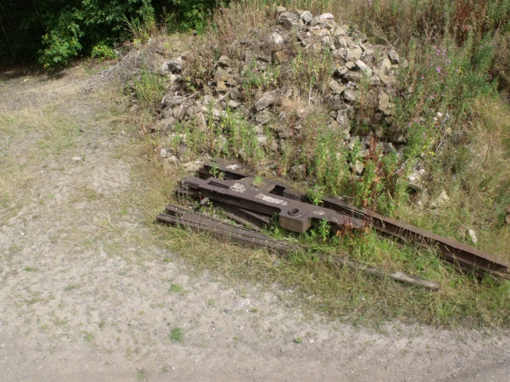 an abandoned train that is laying on the ground