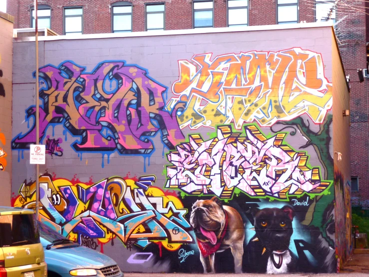 a bunch of graffiti painted on the side of a building