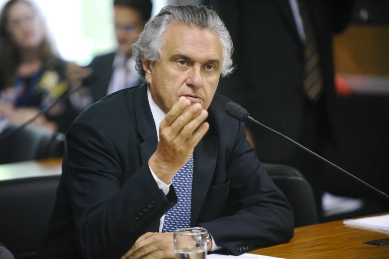 a man in a suit and tie at a conference