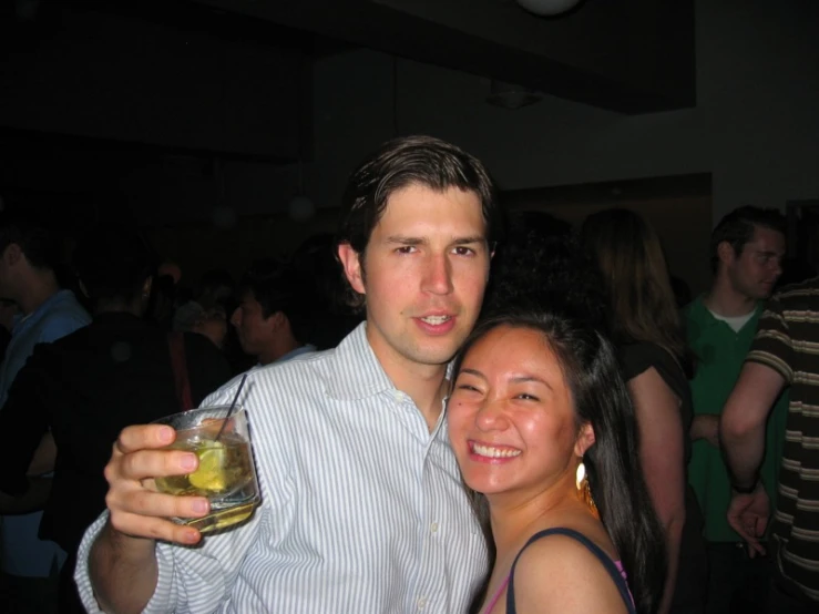 a couple is smiling and drinking some beer