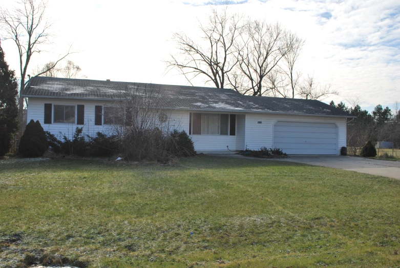 a home sitting on a side walk next to grass