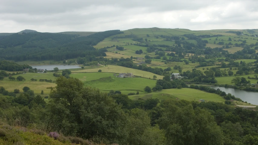 an area with a valley, forest, and several lakes