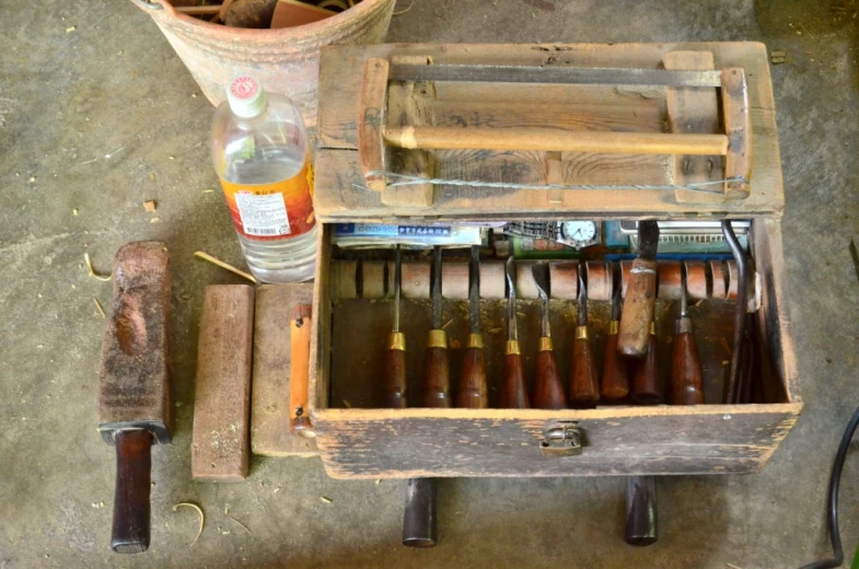 an antique box holds knives and a lot of other items