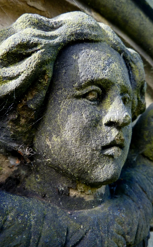 a statue of a woman's head with long hair and huge curls