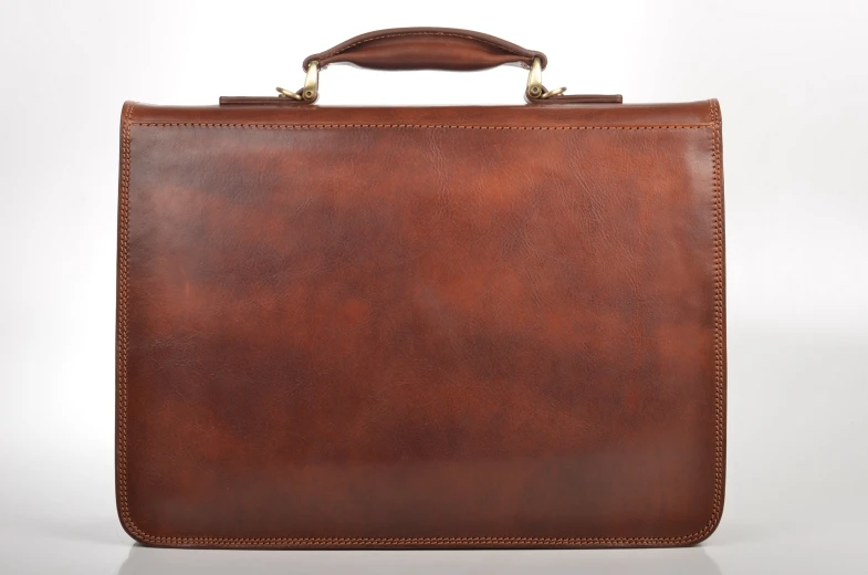 a brown briefcase on a white surface