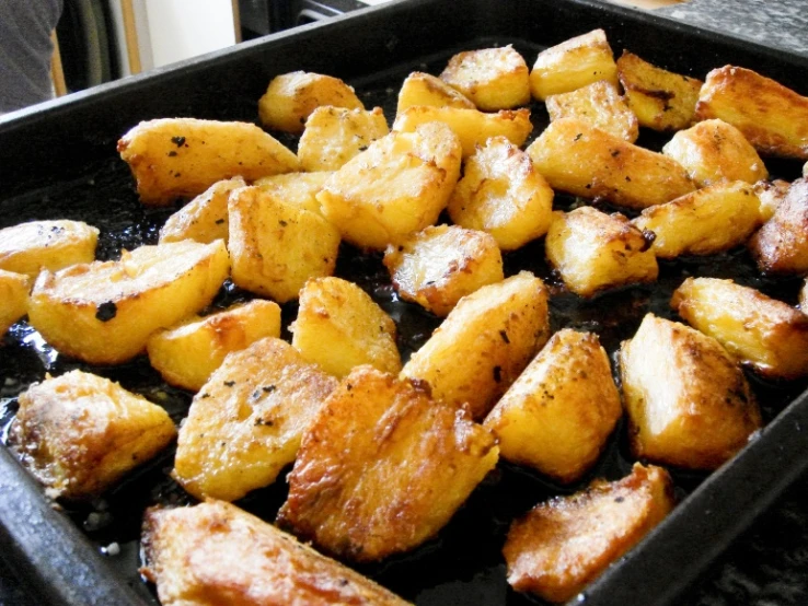 the dish is prepared with potatoes in a pan