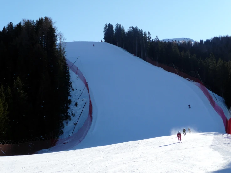 two people are skiing down a mountain on skis