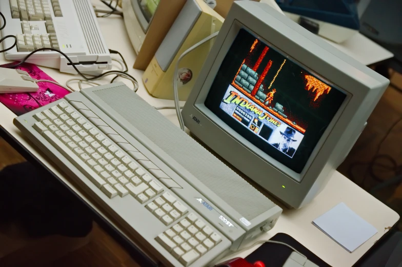 an old computer with keyboard and monitor sitting on a desk