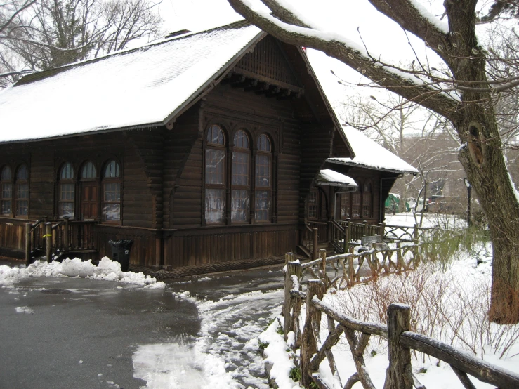 a rustic wooden cabin with a snow covered yard