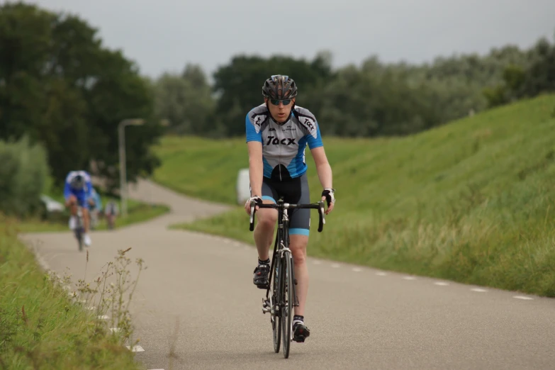 there are two cyclists riding on the road