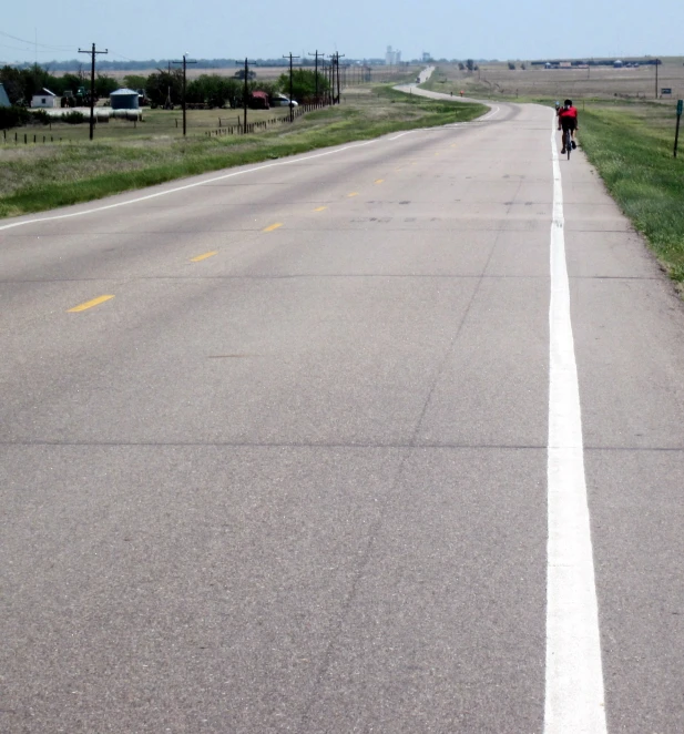 a person on a motorcycle riding down the road