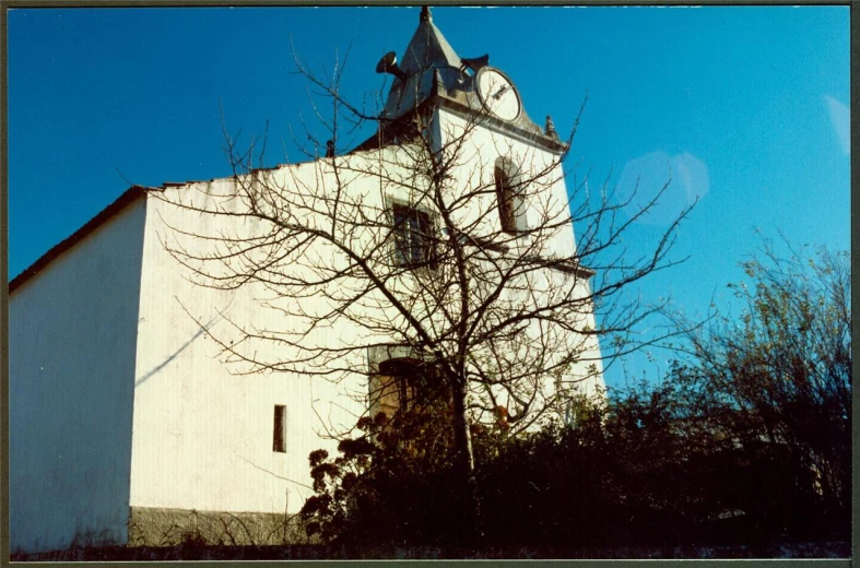 the tall clock tower sits on top of a building