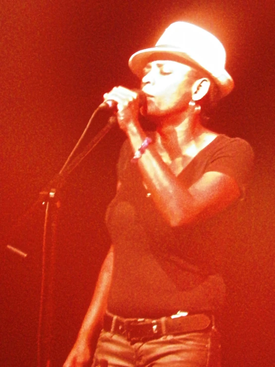 a woman is singing into a microphone