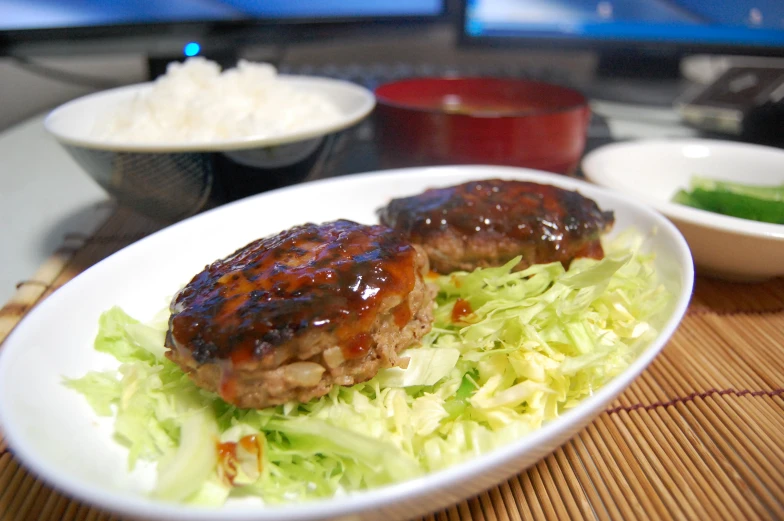 two meatballs and cabbage are sitting on a plate