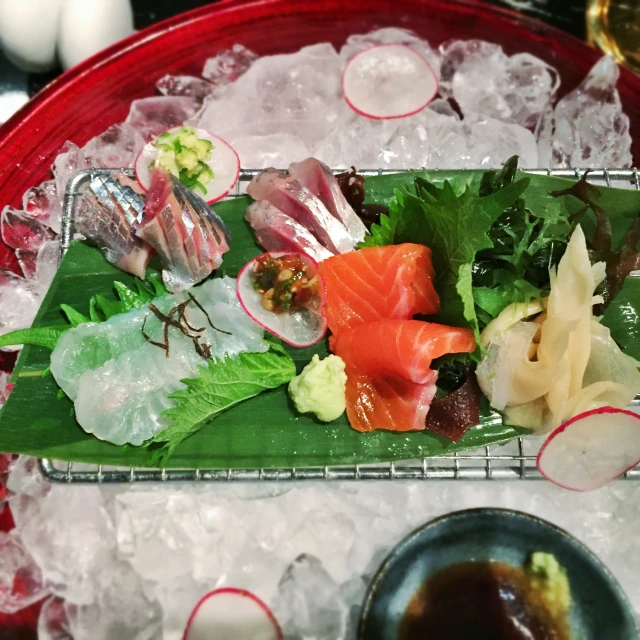 sushi platter in ice with glass serving bowls