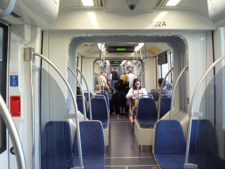 several people sitting on seats inside of a public transit bus