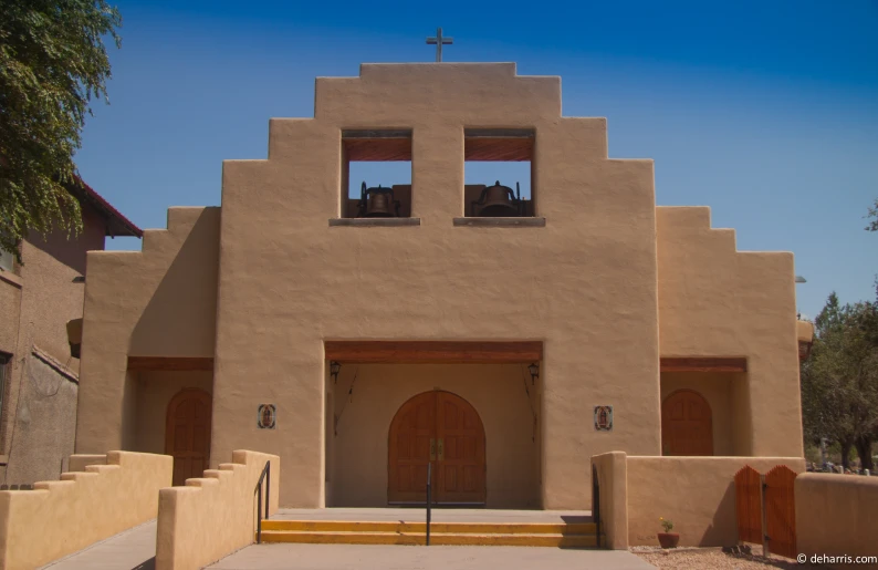 a church with several windows and tall brown towers